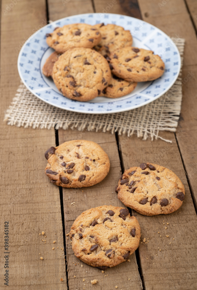 Chocolate chip cookies on a plate over a wooden table Chocolate chip cookies on a plate over a wooden table