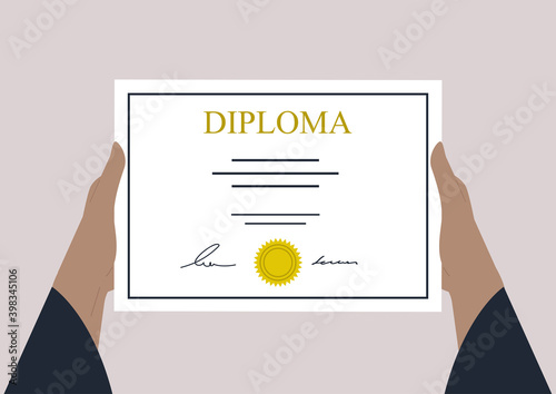 Hands holding a High school graduation certificate
