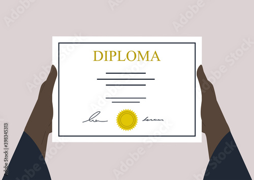 Hands holding a High school graduation certificate