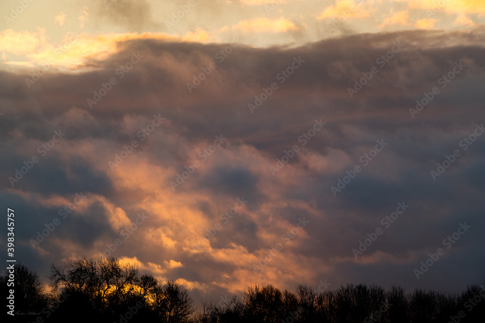 beautiful sunset through bubbling, billowing, illuminated cloud 