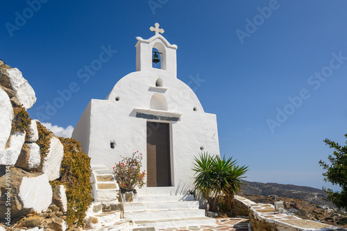 A small white chapel on the top of a hill in the city center of Chora on Ios Island. Cyclades, Greece