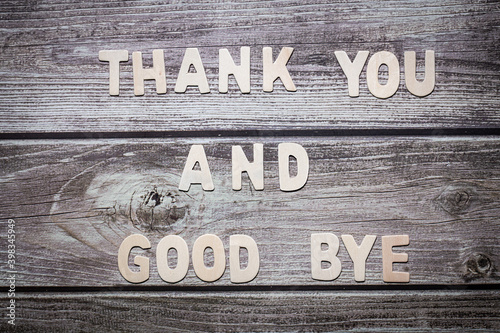 Thank you and good bye wooden words letter written on a wooden board photo