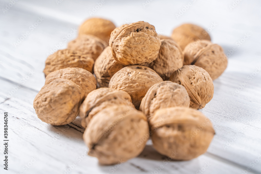Walnuts kernels on white wooden desk, stock photo Walnuts kernels on white wooden desk, stock photo