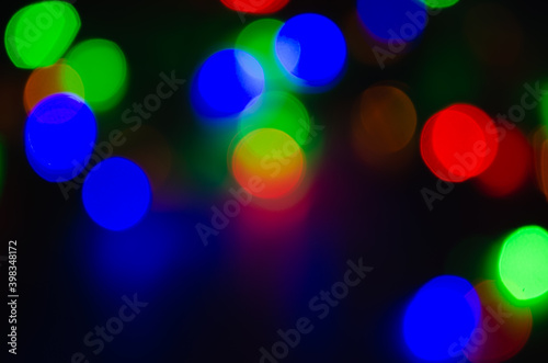 Abstract pattern of colorful bokeh lights on dark background