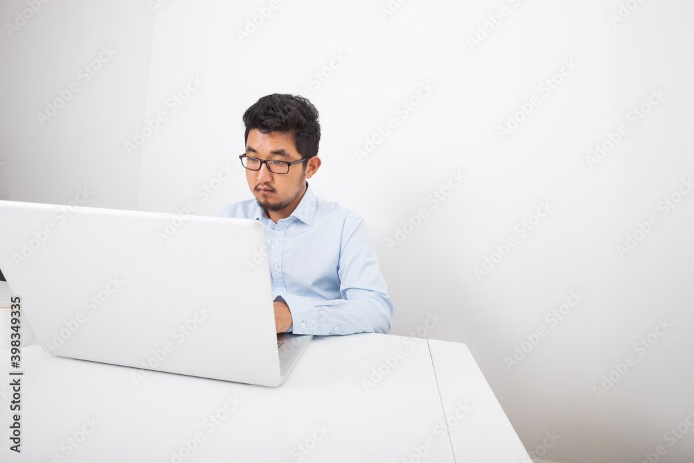 Businessman working on laptop at desk in office