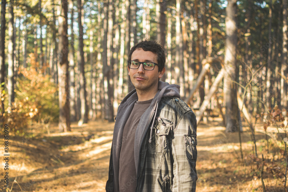 Portrait of young man with glasses in forest Portrait of young man with glasses in forest