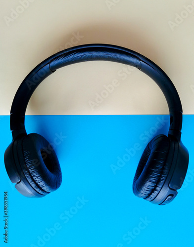 Audio headphones on a beige and blue background. Relax time for music photo