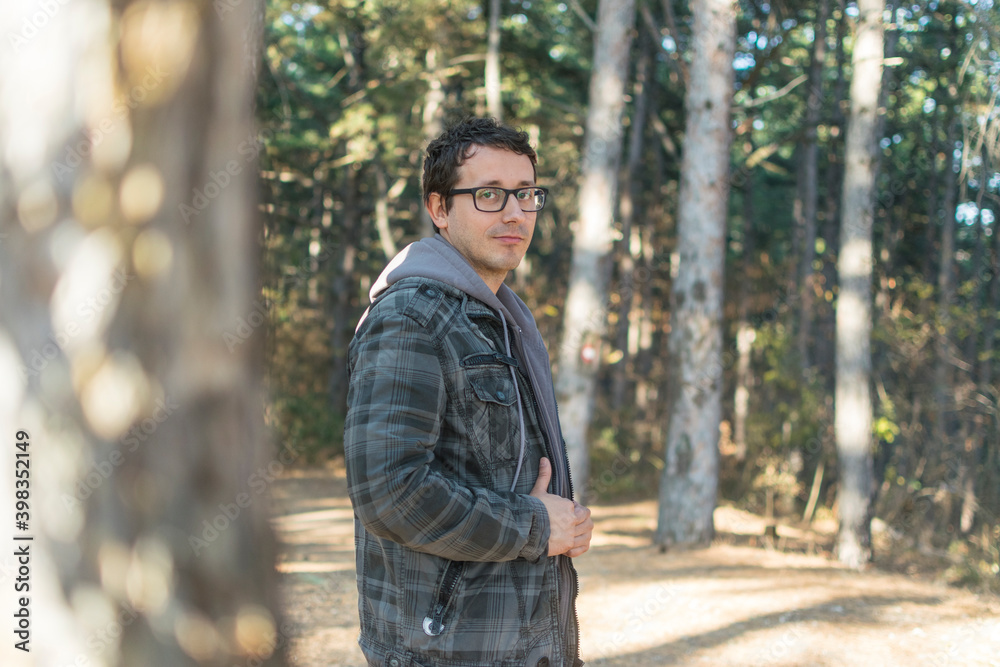Portrait of young man with glasses in forest Portrait of young man with glasses in forest