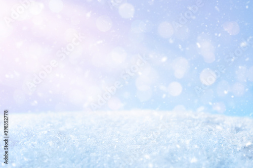 Abstract Christmas blue background with sun rays, flying snow. Merry Christmas. Happy new year. © Yulik art