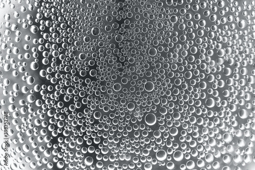 wet glass surface with water drops, toned in ultimate grey