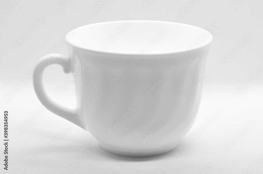 White cup on light background with selective focus White cup on light background with selective focus