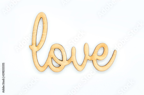 Wooden love text inscription on white background.