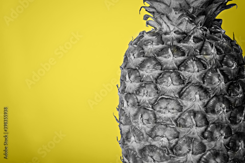 Gray pineapple close-up on a yellow background. Colors of the year 2021. photo