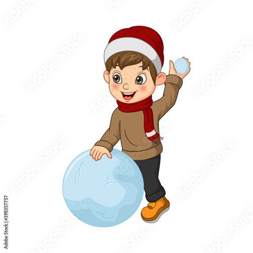 Cute little boy in winter clothes playing a snowball