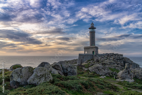 the lighthouse at Punta Nariga in warm evening light on the coast of Galicia in Spain