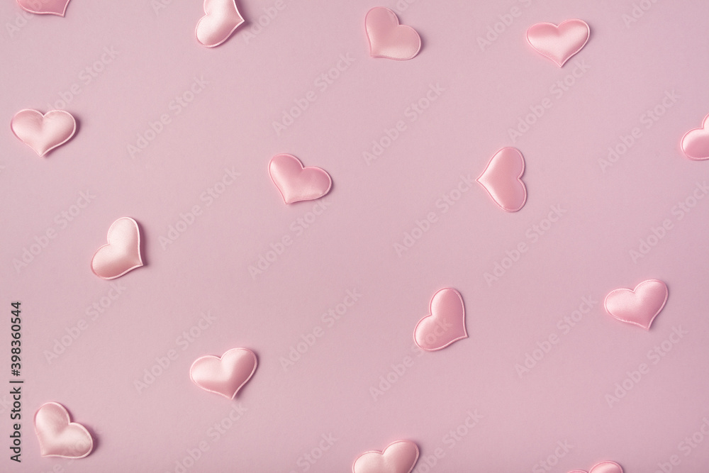 Festive pink background. Pink satin hearts on a pink background. Valentine's Day. Wedding. Birthday. Flat lay, top view.