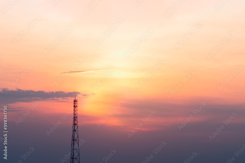 A view of the signal tower at sunset in vibrant orange pinks and violet colors.
