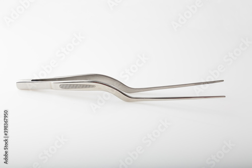 Metal chef tongs to decorate gourmet dishes, which help put small ingredients on the plate.