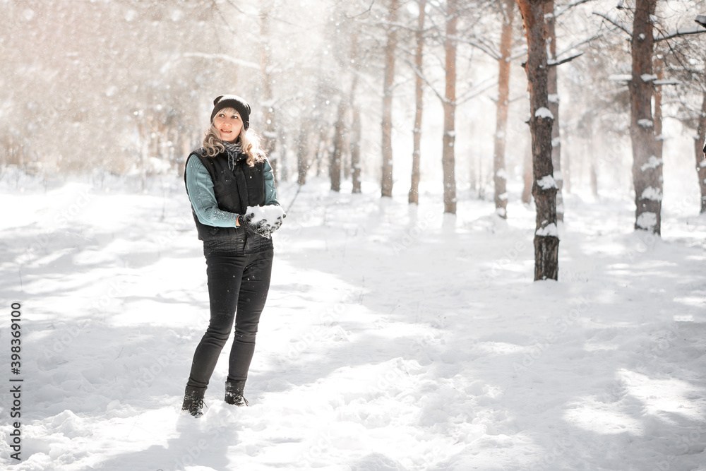 Woman in forest during blizzard. Unexpected snowstorm and snowfall concept.