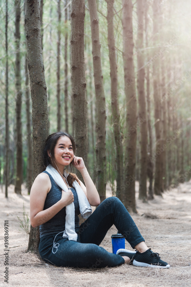 Beautiful sport young woman girl lifestyle exercise healthy drinking water from bottle after running workout in forest nature park with copy space Beautiful sport young woman girl lifestyle exercise healthy drinking water from bottle after running workout in forest nature park with copy space