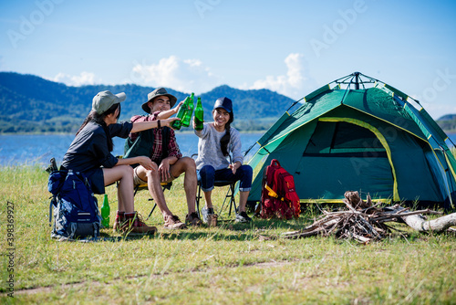 Camping camp in nature happy friends party and drinking beer together in summer at nature forest