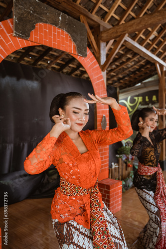 portrait young women presenting traditional Javanese dance movements photo