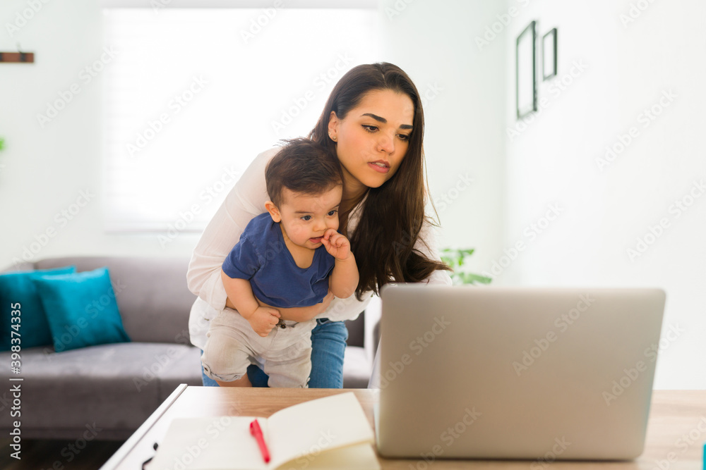 Busy mom working from home and babysitting Busy mom working from home and babysitting
