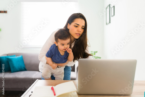 Busy mom working from home and babysitting