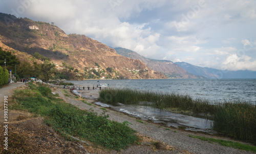 Coastal road along lake Atitlan with pier along mountainrange at Panajachel, Guatemala