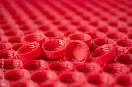 recycling plastic concept. red abstract background of plastic caps from a bottle, top view, short focus