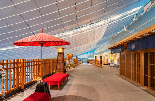 Vermilion colored Nodategasa paper umbrella and japanese lantern in front of the haneda-nihonbashi bridge in the Edo-koji alley of Edo Market Place in Haneda Airport. photo