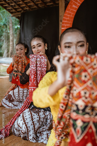 portrait of three young women presenting traditional Javanese dance movements