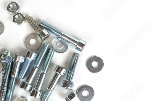 on a white background galvanized metal fasteners close up