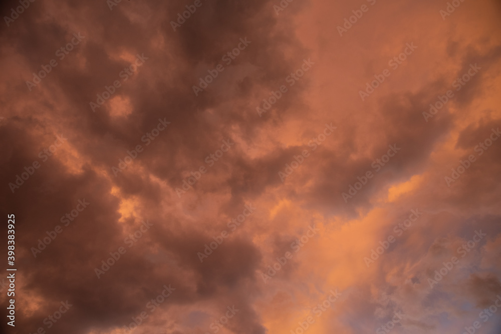 Beautiful sky background. Dramatic orange, pink and gray clouds. Perfect for sky replacement. High quality photo