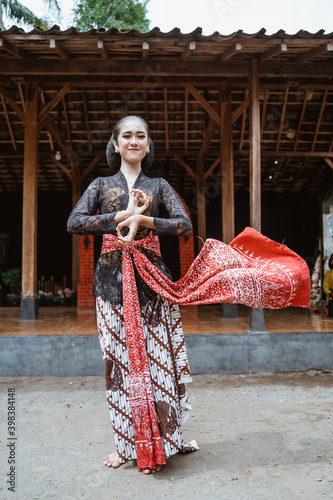 portrait young women presenting traditional Javanese dance movements photo