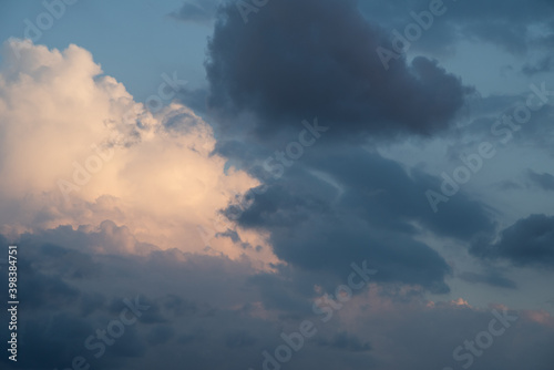 Beautiful sky background. Light blue sky with dramatic orang, pink, and gray clouds. Perfect for sky replacement. High quality photo