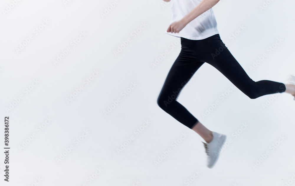 energetic sportswoman running on a light background in sneakers cropped view Copy Space energetic sportswoman running on a light background in sneakers cropped view Copy Space