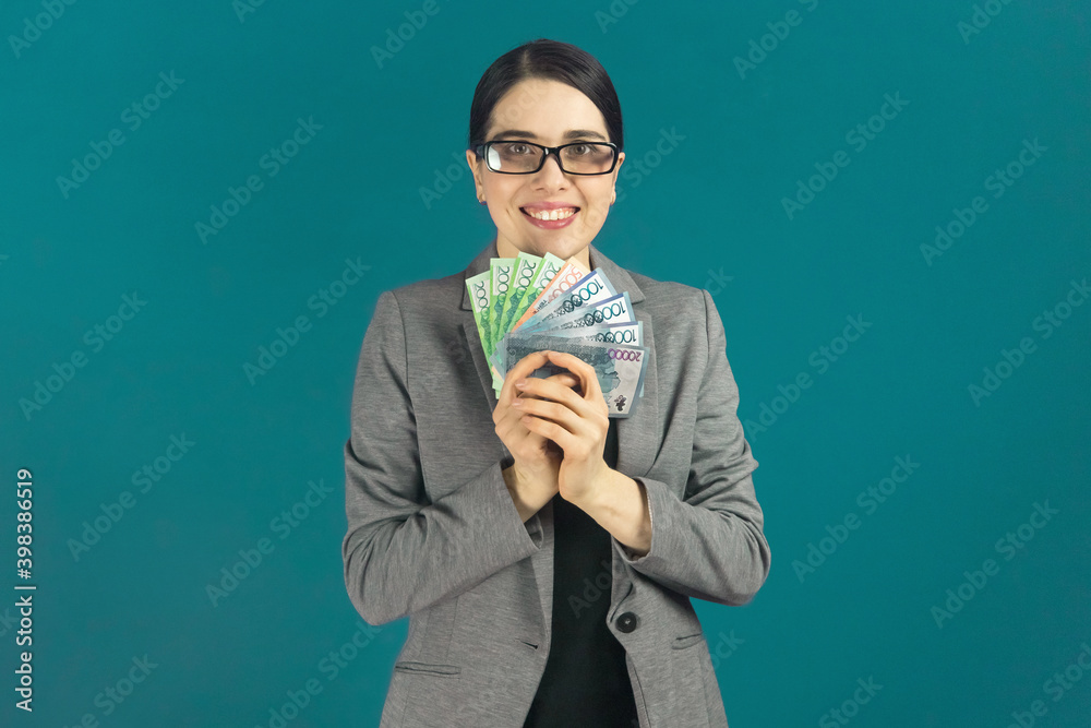 Happy smiling young woman in glasses with Kazakhstan tenge in your hands. Happy smiling young woman in glasses with Kazakhstan tenge in your hands.