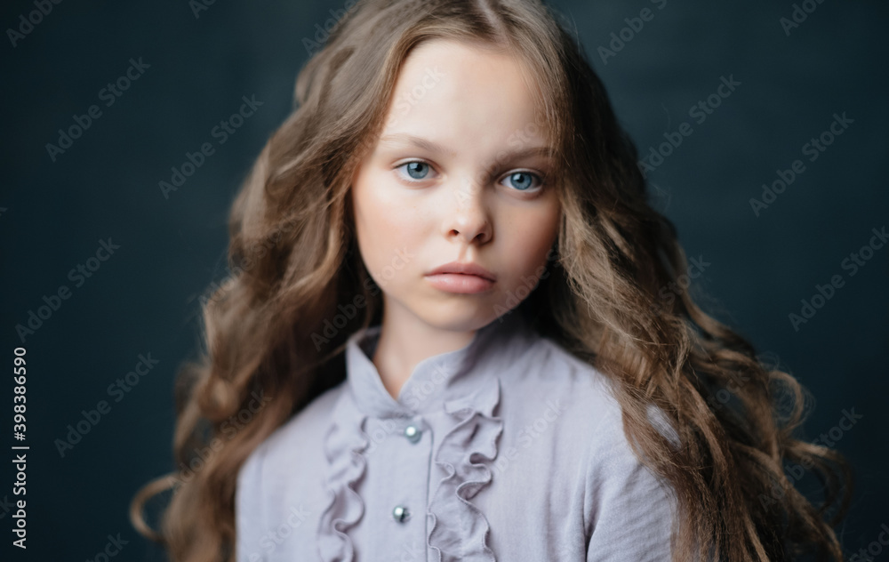 Naklejka premium Beautiful little girl in luxury dress hairstyle Studio