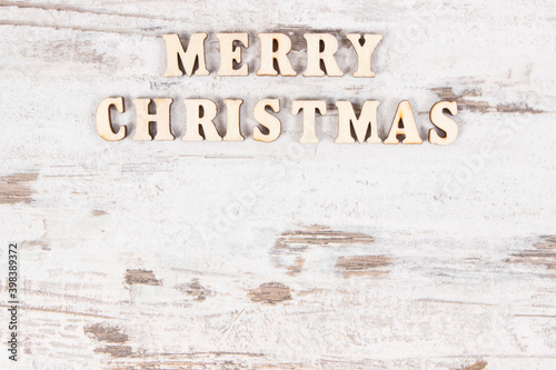 Inscription Merry Christmas on rustic board, festive time concept, place for text