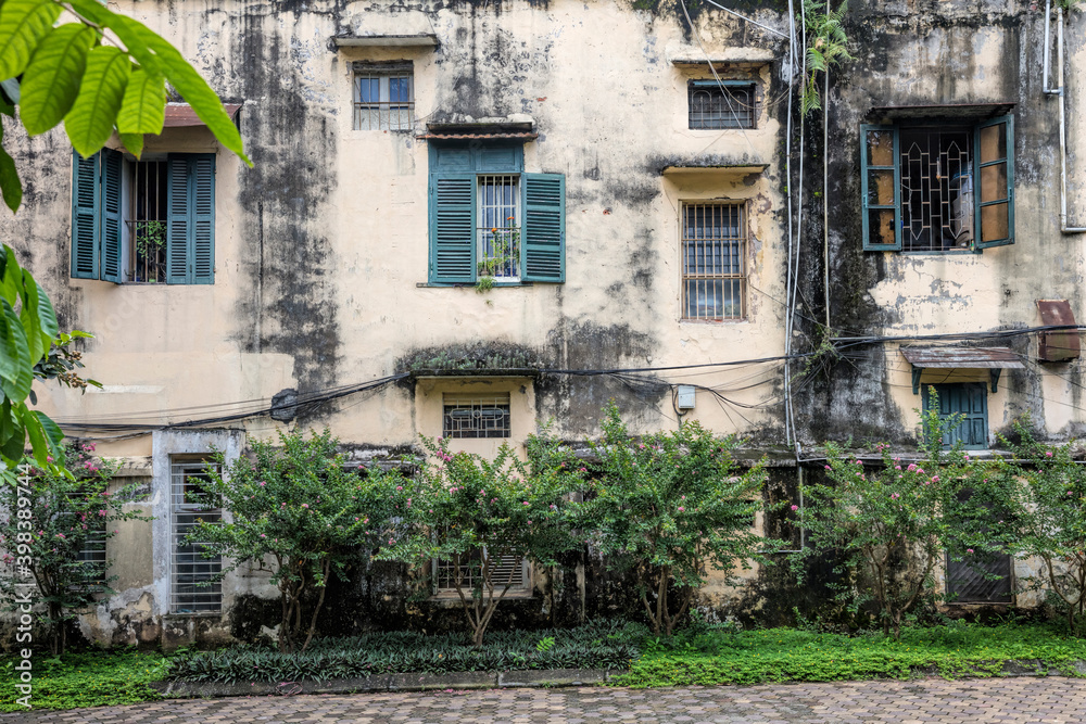 Grungy apartment blocks with green shuttered windows and plants in the old quarter of Hanoi, Vietnam Grungy apartment blocks with green shuttered windows and plants in the old quarter of Hanoi, Vietnam
