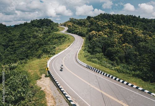 Bilde på lerret Aerial view of tourist riding a motorcycle on beautiful steep curved road (look like number 3) on the high mountain in Nan province, Thailand