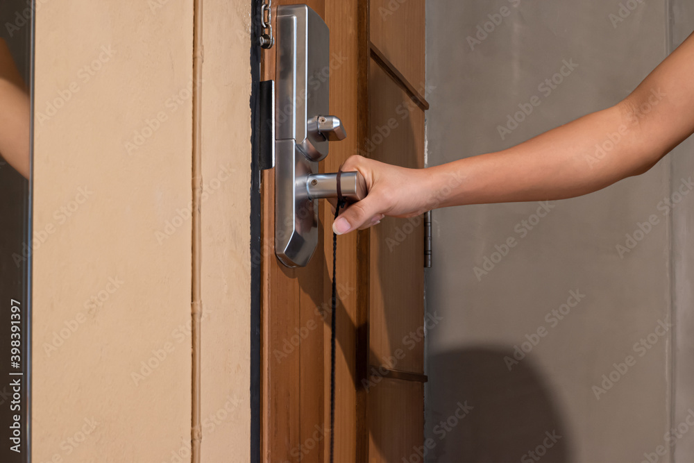 Man hand is about to open the door, closeup. Interior design Man hand is about to open the door, closeup. Interior design