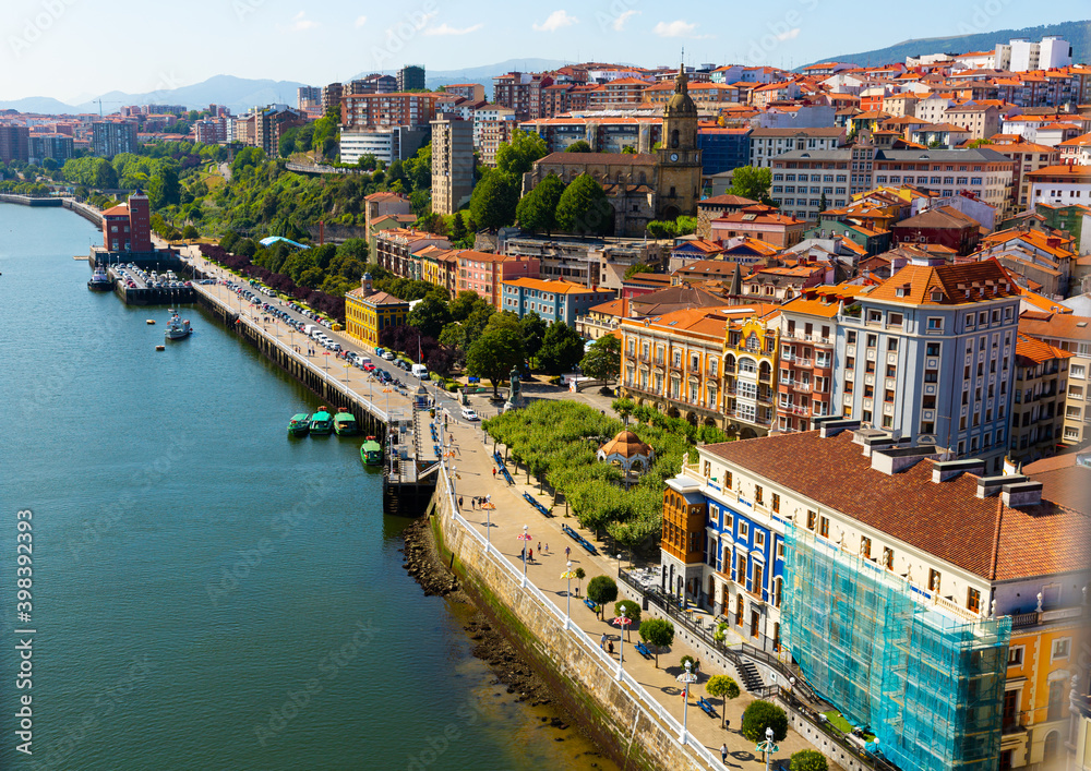 View from Vizcaya Bridge of Portugalete cityscape overlooking medieval Gothic Basilica, Basque Country, Spain..