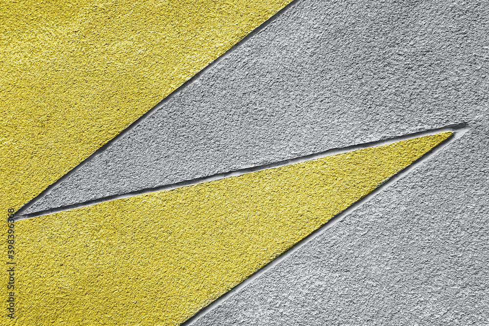 Yellow and gray stone wall with geometric pattern, background, texture. Trendy colors 2021 Yellow and gray stone wall with geometric pattern, background, texture. Trendy colors 2021