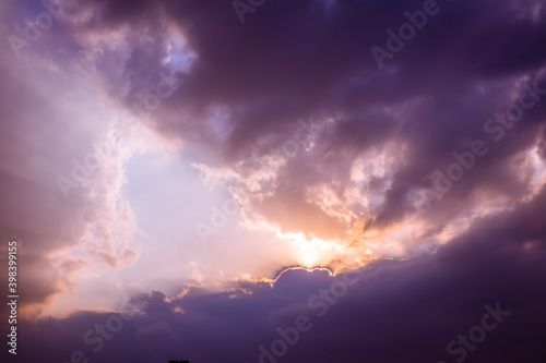 Dramatic threatening sky clouds sunrise after tropical rain thunder storm with bright sun, Abu Dhabi - United Arab Emirates