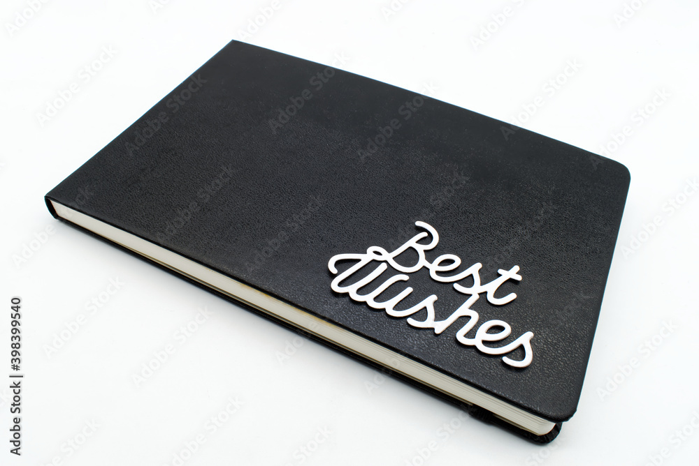 Black leather notebook with best wishes text on the cover Black leather notebook with best wishes text on the cover