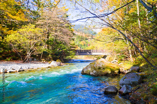 Azusa River flowing through Kamikochi national park in Nagano Prefecture, Japan. The autumn leaves season is beautiful.
