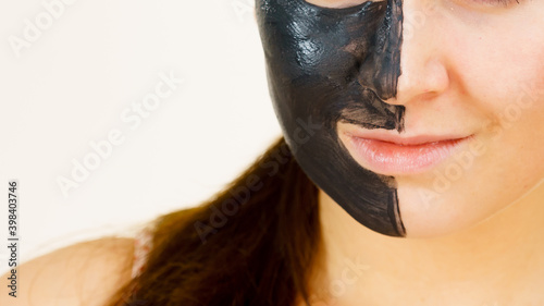 Woman with charcoal facial mask
