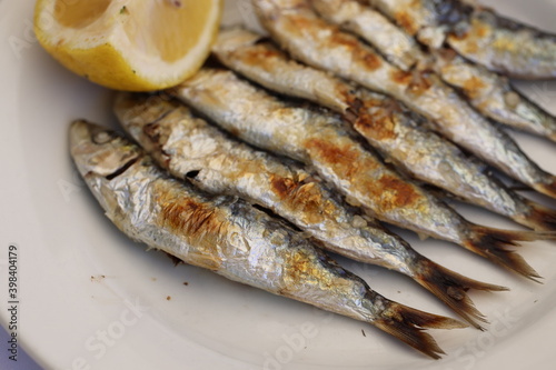 Malaga spits with lemon slice in macro scale. Sardines
